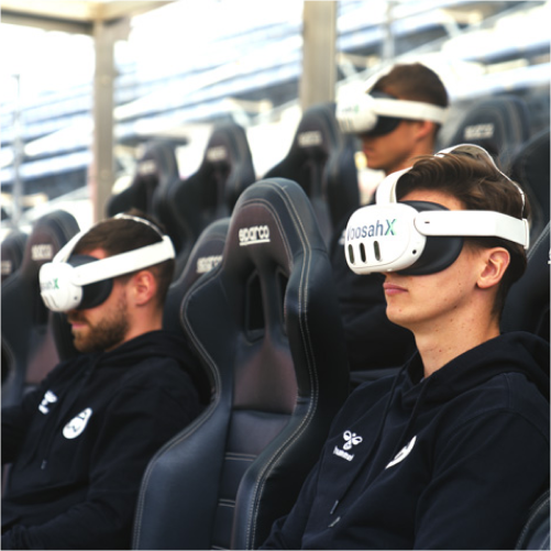 Athletes wearing WoosahX headsets in stadium seats